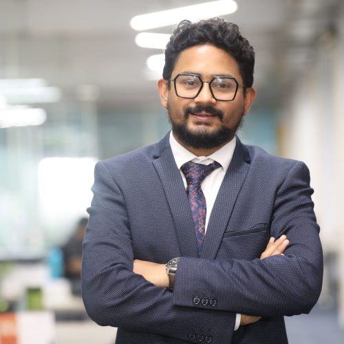 pexels-photo-31851560-31851560 Confident man in a suit standing in a modern office, showcasing professionalism.
